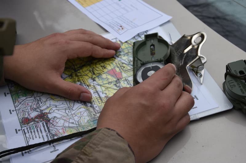 A Soldier plots points on a terrain map during land navigation training at Fort Benning. U.S. Army photo by PFC Lilyanna Martinez.